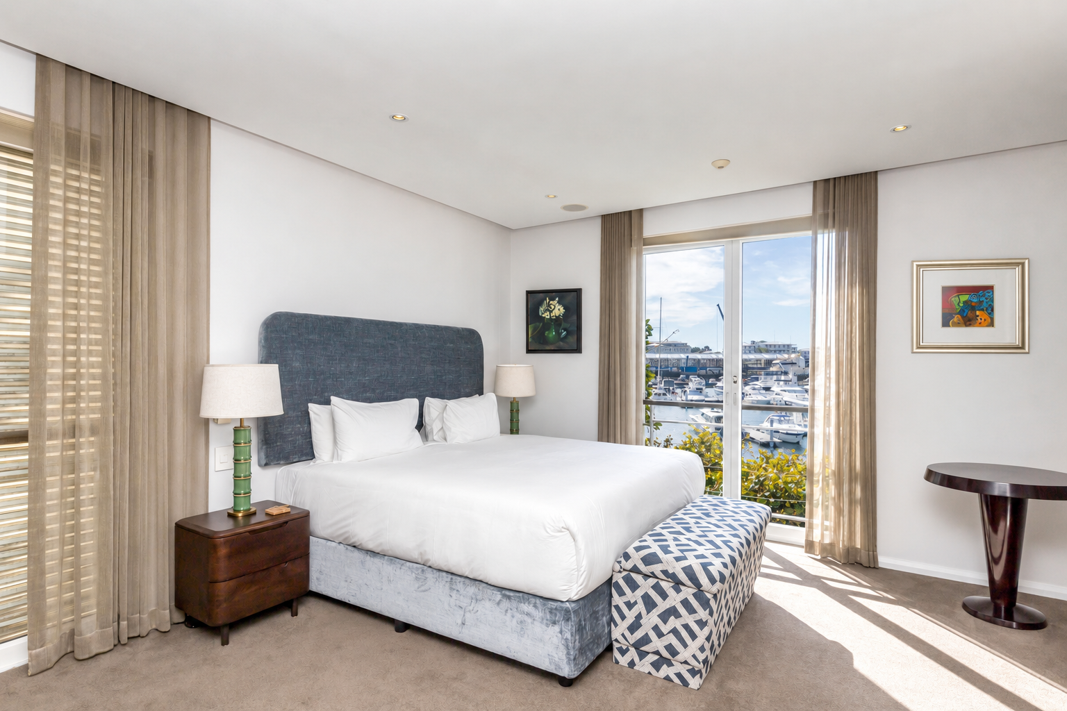 Parergon 106 main bedroom with king bed, blue headboard and marina views